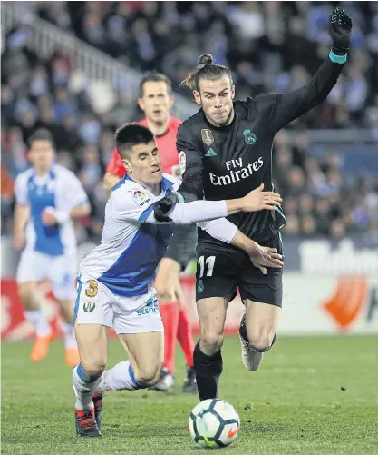  ??  ?? Real Madrid’s Gareth Bale, right, vies with Leganes’ Unai Bustinza.