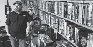  ?? Photos by Jerry Lara / Staff photograph­er ?? Drilling engineer Jason Dyer has more than 3,000 VHS tapes. He also cleans and repairs VCRs. “It always leads back to nostalgia,” he says of VHS collecting.