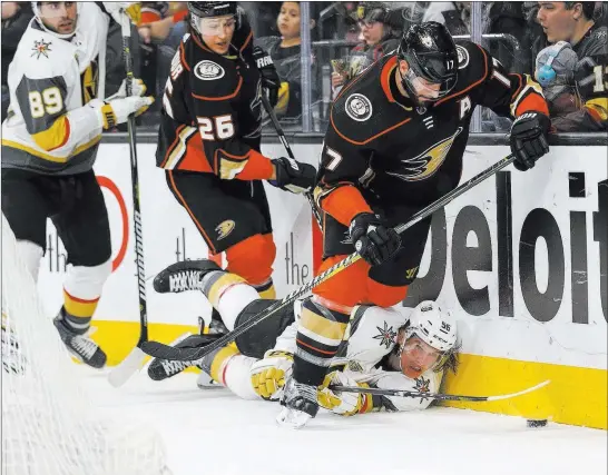  ?? Richard Brian ?? Las Vegas Review-journal @vegasphoto­graph Anaheim Ducks center Ryan Kesler (17) looks to control the puck as Golden Knights left wing Erik Haula (56) falls to the ice during the third period of Monday’s game at T-mobile Arena. Josh Manson and Jakob...