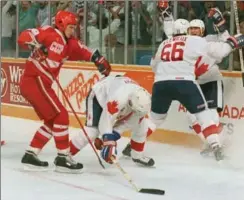  ??  ?? Mario Lemieux rushes into the arms of teammate Wayne Gretzky after scoring the winning goal in Game 3 of the 1987 Canada Cup final, 30 years ago today.