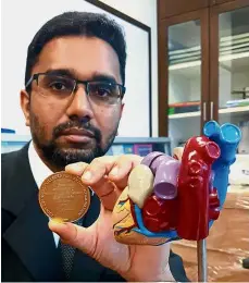  ??  ?? A doctor with heart: Dr Basheer holding his McCormack Medal.