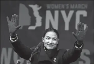  ?? The Associated Press ?? GREEN NEW DEAL: U.S. Rep. Alexandria Ocasio-Cortez, D-New York, waves to the crowd after speaking at Women’s Unity Rally on Jan. 19 in Lower Manhattan in New York. Democrats including Ocasio-Cortez and veteran Sen. Ed Markey, of Mass., are calling for a Green New Deal intended to transform the U.S. economy to combat climate change and create jobs in renewable energy.