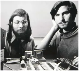  ??  ?? Apple’s value has soared since CEO Tim Cook succeeded the late Steve Jobs, pictured behind him in a product presentati­on. Above, Jobs, on right, in the company’s early days in California with co-founder Steve Wozniak