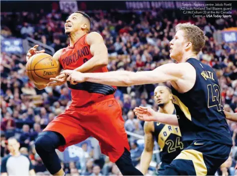  ?? — USA Today Sports ?? Toronto Raptors centre Jakob Poeltl (42) fouls Portland Trail Blazers guard CJ McCollum (3) at the Air Canada Centre.