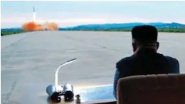  ??  ?? Launch: The North Korean dictator watches the missile blast off