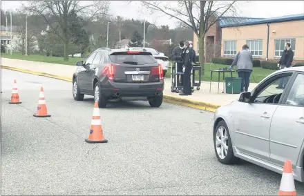  ?? MEDIANEWS GROUP FILE PHOTO ?? Cars line up to receive Chromebook computers provided by the Spring-Ford Area School District in April after schools were closed.