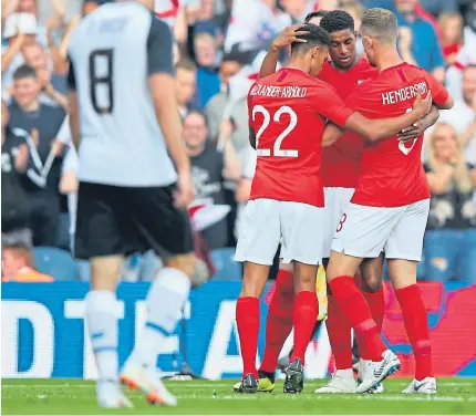  ?? Getty. ?? Marcus Rashford celebrates his goal with Jordan Henderson and Trent Alexander-arnold.