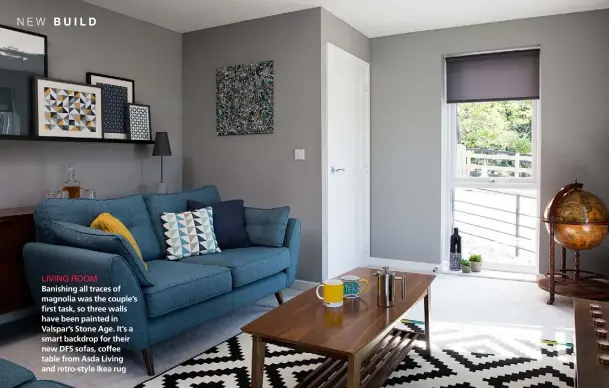  ??  ?? LIVING ROOM Banishing all traces of magnolia was the couple’s first task, so three walls have been painted in Valspar’s Stone Age. It’s a smart backdrop for their new DFS sofas, coffee table from Asda Living and retro-style Ikea rug