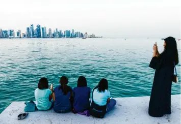  ?? Foto: Imago Images ?? Frauen stehen in Doha an der Seepromena­de.