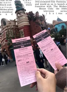  ??  ?? Visitors hold up their tickets as they wait in line to see Mickey Mouse during an event commemorat­ing the 90th birthday of the Disney character, in Tokyo Disneyland, Urayasu, Chiba Prefecture, Japan Nov 18 in this picture obtained from social media.