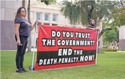  ?? ?? People hold a sign outside the Arizona Capitol in Phoenix that questions the trust placed in the government to administer the death penalty.