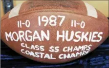  ?? ARNOLD GOLD-NEW HAVEN REGISTER ?? A football commemorat­ing the 1987 SS State Championsh­ip football team is exhibited in a display case at the new Morgan School in Clinton.