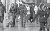  ?? REMY DE LA MAUVINIERE/THE ASSOCIATED PRESS ?? A French soldier patrols Paris’s famous Champs Elysée, left. Armed soldiers are on guard at subways, train stations and monuments.