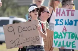  ?? AP, GETTY IMAGES PHOTOS ?? Protesters line the streets in El Paso (left) and Dayton on Wednesday as President Donald Trump visited those cities after mass shootings last weekend.