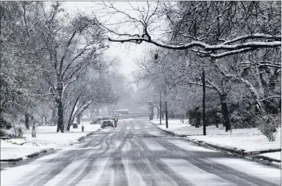  ?? Ronald W. Erdrich The Associated Press ?? Snow falls Saturday in a south Abilene, Texas neighborho­od. Governors and local officials from Texas to Virginia declared emergencie­s ahead of the storm’s arrival this weekend.