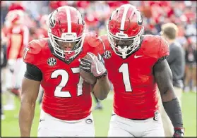  ?? CURTIS COMPTON/CCOMPTON@AJC.COM ?? Georgia tailbacks Nick Chubb (left) and Sony Michel share a pregame moment of solidarity. Both decided to forgo the NFL and return for their senior year at UGA.