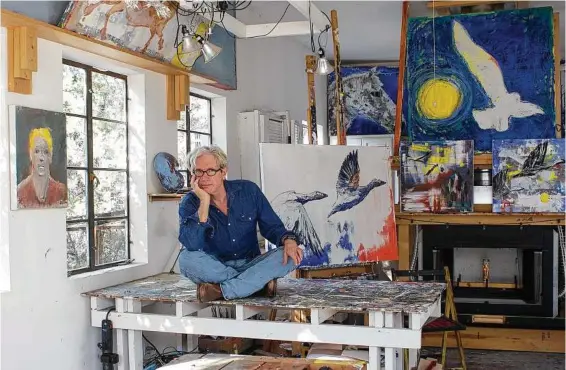  ??  ?? Singer-songwriter Sam Baker, pictured in his Austin studio, has also made a name for himself in the art world.