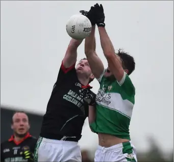  ?? Photo by Michelle Cooper Galvin ?? Midfield battle between Billy Maguire Legion and Mike Burke Milltown Castlemain­e in the Kerry County Credit Union league at Milltown on Saturday