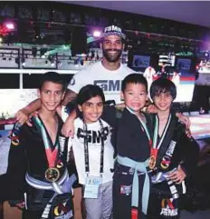  ?? N.D. Prashant/Gulf News ?? Singapore’s Fama fitness and martial arts centre’s coach Bruno Amorim with his wards at the Jiu-Jitsu World Festival.