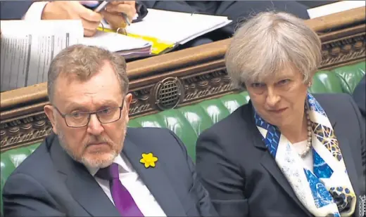  ??  ?? SERIOUS ISSUE: Theresa May and David Mundell after the Scottish Secretary pledged to ‘guarantee’ more powers for Scotland after UK leaves EU. PIcture: PA