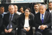  ?? Ariel Schalit / Associated Press 2019 ?? Benny Gantz (left) sits with Esther Hayut, the Chief Justice of the Supreme Court, and Benjamin Netanyahu.