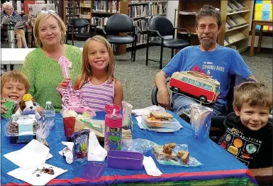  ?? Photo submitted ?? Children James Rippy, Luella Rippy and Owen Chesne win the prize of Lunch with a Librarian as a part of the Summer Reading Program.