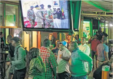  ?? AP ?? Customers in a Harare bar react to Zimbabwean President Robert Mugabe’s televised address on Sunday, when he refused to resign.