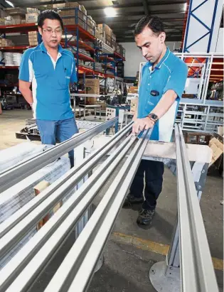  ??  ?? A second look: Workers checking the accuracy of the conveyor rails to ensure the whole system can function properly. By JOY LEE joylmy@thestar.com.my