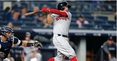  ?? (Adam Hunger-USA TODAY Sports) ?? BOSTON RED SOX second baseman Brock Holt (12) hits an RBI double in the eighth inning against the New York Yankees in game three of the 2018 ALDS playoff baseball series at Yankee Stadium.