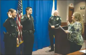  ?? NEWS-SENTINEL PHOTOGRAPH­S BY BEA AHBECK ?? New Lodi Police Officers Regan Porteous and Joseph Hughes are sworn in by city clerk Jennifer Ferraiolo during a Lodi Police Department badge pinning and promotion ceremony at Carnegie Forum in Lodi on Thursday.