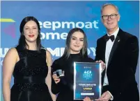  ??  ?? ●●Chloe Johnson, Young Employee of the Year, is presented with her award by Jenna Brown, from Keepmoat Homes, and council chief executive Steve Rumbelow