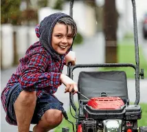  ?? VANESSA LAURIE/STUFF ?? Kayden Potroz-Wallis, 11, has set up his own lawnmowing business, charging $35 per lawn, and has his sights set on a new Xbox.