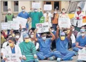  ?? ANI FILE ?? Doctors hold placards during a protest over the delay in the NEET -PG counsellin­g in New Delhi.