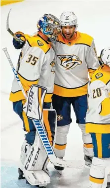  ?? THE ASSOCIATED PRESS ?? Nashville Predators goaltender Pekka Rinne, left, and Mike Fisher celebrate a 5-0 series-winning victory against the Colorado Avalanche in a first-round playoff series Sunday in Denver.