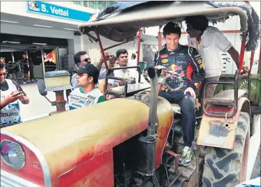  ?? VIRENDRA SINGH GOSAIN / HT PHOTO ?? Being an F1 driver requires a great deal of skill and some real cojones. Driving a tractor requires all that and more as Red Bull’s Australian driver Mark Webber found out at the BIC on Thursday.