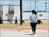  ?? ERIC GAY/AP ?? Immigrants seeking asylum walk in August at the ICE South Texas Family Residentia­l Center in Dilley, Texas.