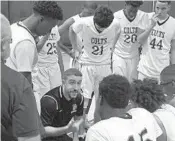  ?? DAVID FURONES / STAFF PHOTO ?? Coral Springs coach Devin Barta instructs his players during a third-quarter timeout in his Colts’ home game against Dillard on Tuesday night.