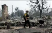  ?? MARCIO JOSE SANCHEZ — ASSOCIATED PRESS ?? Capt. Scott Fisher, with the San Bernardino County Fire Department, surveys a wildfire-damaged neighborho­od in Keswick, Calif., on Sunday.