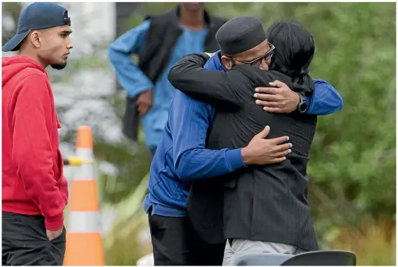  ?? IAIN McGREGOR/STUFF ?? Mourners embrace at Christchur­ch’s Memorial Park Cemetery yesterday after attending the funeral services for Cashmere High School student Sayyad Ahmad Milne and Tariq Rashid Omar.