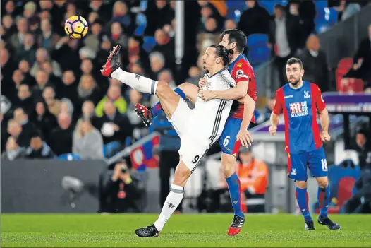  ?? Picture: AFP ?? RED-HOT CHARACTER: Crystal Palace’s defender Scott Dann holds on to Manchester United’s striker Zlatan Ibrahimovi­c during their English Premier League match at Selhurst Park in south London. United manager Jose Mourinho has heaped praise on the Swede...