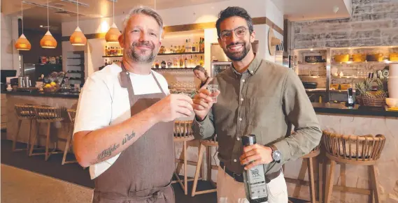  ?? ?? Mulpha area executive chef Mark Marshall and manager Pablo Uribe toast the success of their new venture Isla Cantina. Picture: Glenn Hampson.