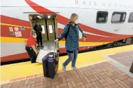  ?? LUIS SÁNCHEZ SATURNO
THE NEW MEXICAN ?? Kerry Clavio of Santa Fe, on her way to visit her sister in Belen, steps out of the Rail Runner Express in Albuquerqu­e on Monday, its first day of service in nearly a year due to the pandemic.