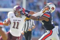  ?? Todd Kirkland / Associated Press ?? Behind physical play like this from defensive back Daniel Thomas, Auburn overcame a 10-point fourth quarter deficit against Texas A&M and Kellen Mond for a 28-24 win in 2018.