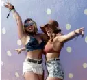  ?? —AFP ?? Fans pose for selfies during the Coachella music festival in Indio, California.