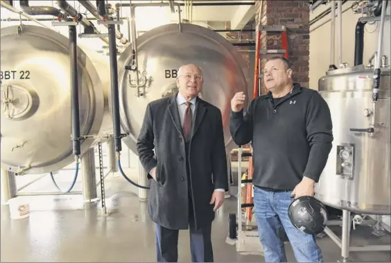  ?? Photos by Lori Van Buren / Times Union ?? Developer JT Pollard, right, takes Congressma­n Paul Tonko on a tour of the Frog Alley Brewing in the Mill Artisan District constructi­on project on Friday in Schenectad­y. The 6,000-foot taproom is scheduled to open March 16.