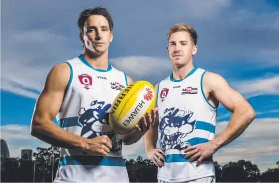  ??  ?? Blake Erickson and Jackson Fisher show off the specially-designed Ladies Day guernseys Broadbeach will wear against Sandgate today. Picture: JERAD WILLIAMS