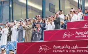  ?? ?? Spectators applaud as the Wathnan Racing-owned bay colt Inverness won the feature - Khor Al Adaid Cup (QA Gr3) - of Qatar Racing & Equestrian Club’s (QREC) 30th Race Meeting at the Al Rayyan Racecourse on Thursday.