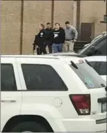  ?? DOMINICO CAPORALI — VIA AP ?? Police escort a person, second from right, out of the Marshall County High School in Benton, Ky., after Tuesday's shootings there.