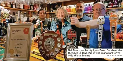  ?? PICTURE: CAMRA ?? Neil Bunch, centre right, and Dawn Bunch receive the CAMRA Town Pub Of The Year award for Ye Olde Whyte Swanne