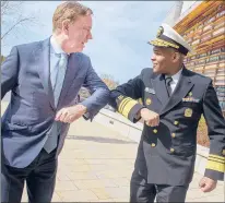  ?? MARK MIRKO/HARTFORD COURANT ?? Gov. Ned Lamont, left, and U.S. Surgeon General Vice Admiral Jerome M. Adams bump elbows instead of shaking hands while in Rocky Hill.